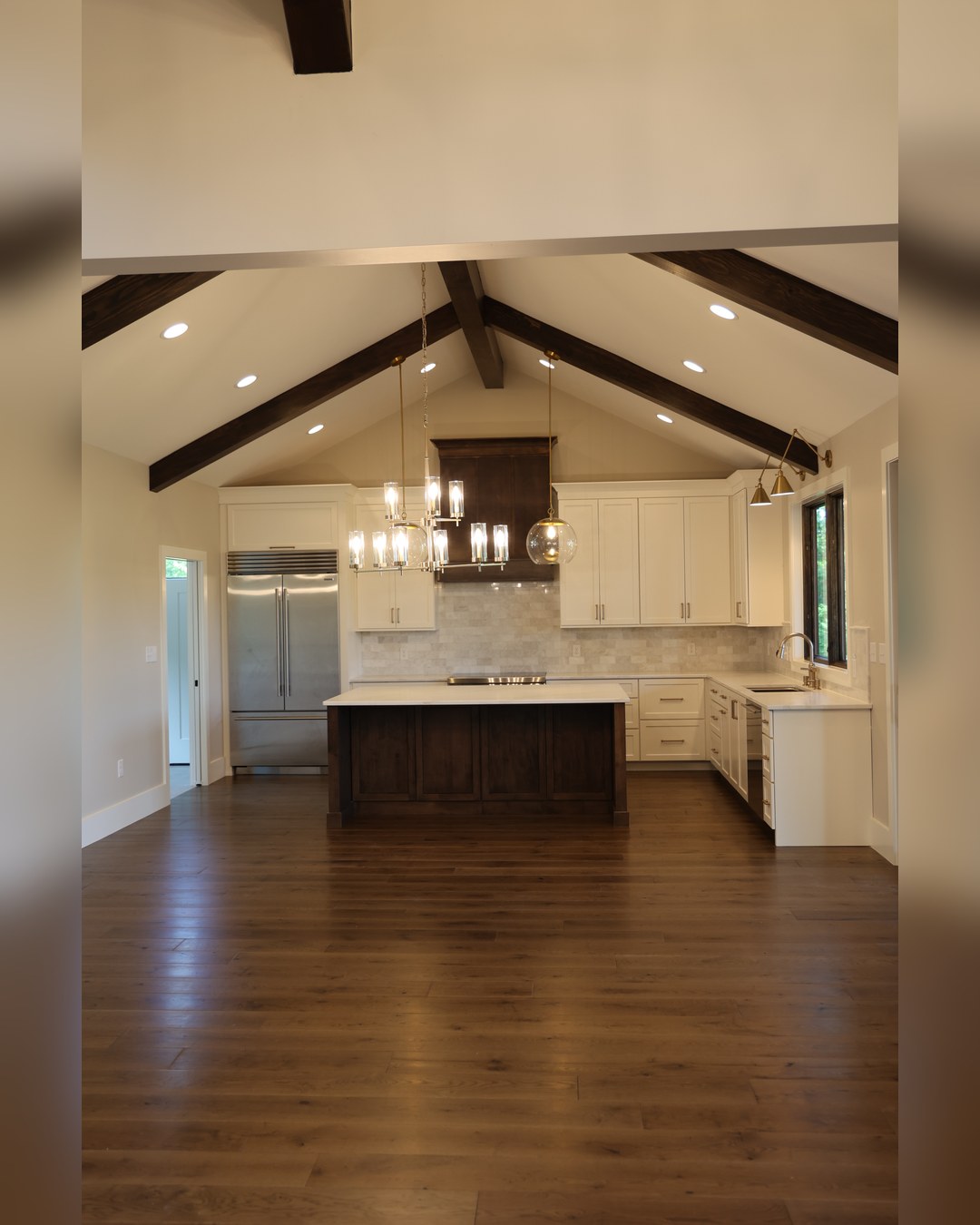 Kitchen under an open truss ceiling